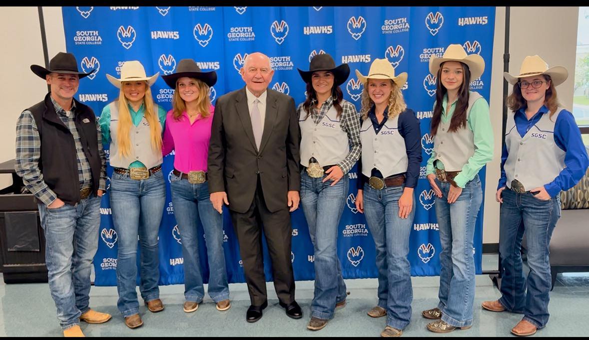 Students in cowboy hats with the Chancellor